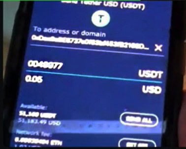 A smartphone screen exhibits a cryptocurrency transaction interface. Displayed are a wallet address, a balance of 0.004077 USDT, and 0.05 USD with options like "Send All" and network fee details, highlighting the importance of vigilance against fake investment scams in digital finance.