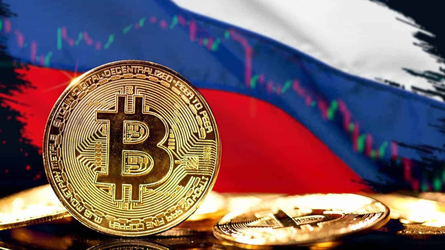 A gold Bitcoin coin stands upright among others, with the Russian flag and a financial chart line graph blurred in the background.